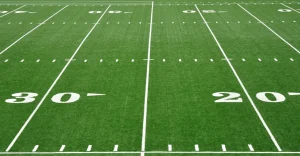 Green football field with yard markers at 30 and 20 yards
