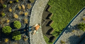 Aerial view of a person laying sod in a landscaped garden area