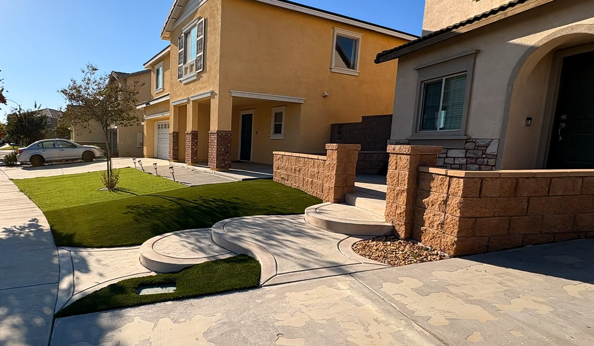 Residential street view with two houses, walkways, and green lawn areas